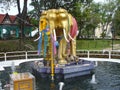 Statue of fused elephants of gold color.