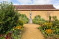 Statue in gardens Barrington Court near Ilminster Somerset England uk with gardens in summer sunshine