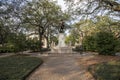 A statue of General James Edward Oglethorpe at Franklin Square with lush green weeping willow trees, plants and grass