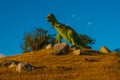 Statue of a giant green dinosaur. Prehistoric animal models, sculptures in the valley Of the national Park in Baconao, Cuba.