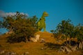 Statue of a giant green dinosaur. Prehistoric animal models, sculptures in the valley Of the national Park in Baconao, Cuba.