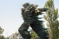 Statue of glass plate running man monument in front of hotel Hilton in Evangelismos in central Athens by Kostas Varotsos. in