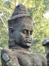Statue of a god on the causeway to Angkor Thom`s south gate