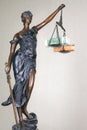 Statue of goddess of justice Themis with money on the libra. The concept of lawlessness and corruption, the flow of finances