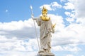 Statue of the goddess Palladus against a blue sky with clouds, rear view, sculpted in front of the Austrian Parliament