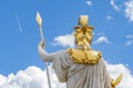 Statue of the goddess Palladus against a blue sky with clouds, rear view, sculpted in front of the Austrian Parliament