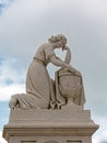 Statue of grieving woman along an urn Royalty Free Stock Photo