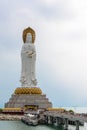 Statue of Guanyin on the territory of Buddhist center Nanshan on a cloudy day