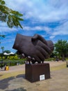 statue of hands shaking hands at Kiara Artha Park Bandung. Royalty Free Stock Photo