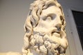 Statue head depicting Serapis god in Greek era .