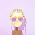 Statue hed with sunglasses. Trendy summer concept. Modern art. Colorful sunglasses covered with slime. On pastel purple background Royalty Free Stock Photo