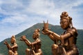 a statue of the hindu deities sitting on a pedestal with another figure standing up Royalty Free Stock Photo