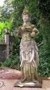 Statue of Hindu God on Bali Island. Hindu God in the royal garden of Tirta Gannga. A statue on a white stone pedestal. Royalty Free Stock Photo