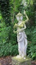 Statue of Hindu God on Bali Island. Hindu God in the royal garden of Tirta Gannga. A statue on a white stone pedestal. Royalty Free Stock Photo