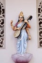 Statue of a Hindu Goddess Saraswati on the wall of temple