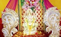 A statue, idol or portraiture of Hindu God Lord Ganesha kept on a table having beautiful decoration.