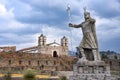 A statue of Inca Pachacutec and Catholic church in Vilcashuaman. Ayacucho, Peru