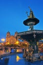 Statue of Inca Pachacutec on fountain and catholic church on Plaza de Armas, evening view, Cusco or Cuzco town, Peru