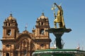 Statue of Inca Pachacutec on fountain and catholic church on Plaza de Armas,