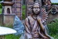 Statue of a Japanese woman holding uchiwa the hand fans used in Japan. Mythology concept