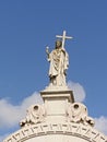 Statue of Jesus christ holding a cross on top of a grave tomb in Altode Sao Joao cemetery, Lisbon Royalty Free Stock Photo