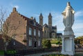 Statue of Jesus in front of the romanesque basilica of the saints Wiro, Plechelmus, and Otgerus in Sint Odilienberg