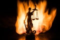 The Statue of Justice - lady justice or Iustitia / Justitia the Roman goddess of Justice on a dark fire background