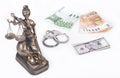 Statue of Justice Themis with money euros and dollars. Bribe and crime concept. Royalty Free Stock Photo