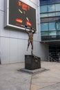 A statue of Kareem Abdul-Jabbar shooting a basketball with his sky hook shot wearing a Lakers uniform with the number 33