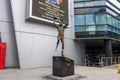 A statue of Kareem Abdul-Jabbar shooting a basketball with his sky hook shot wearing a Lakers uniform with the number 33