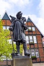 Statue of Kiepenkerl im MÃÂ¼nster in front of old traditional half timbered houses Royalty Free Stock Photo