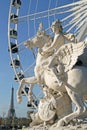 Statue of King of Fame riding Pegasus on the Place de la Concorde with ferris wheel and Eiffel tower at background, Paris, France Royalty Free Stock Photo