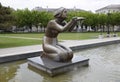 Statue of kneeling woman in the fountain. Water flowing from the hands of the statue