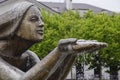 Statue of kneeling woman in the fountain. Water flowing from the hands of the statue