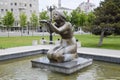 Statue of kneeling woman in the fountain. Water flowing from the hands of the statue