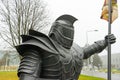 The statue of the knight. The figure of a man in metal armor.