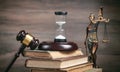 Statue of Lady Justice, hourglass, book and gavel