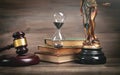 Statue of Lady Justice, hourglass, book and gavel