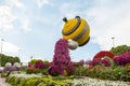 Statue of a large decorative teapot pouring flower tea in botanical Dubai Miracle Garden with different floral fairy-tale themes