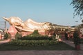 Statue of a large golden reclining Buddha in a park in Vientiane in Laos Royalty Free Stock Photo