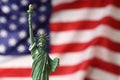 Statue of Liberty against flag of USA, closeup. Space for text Royalty Free Stock Photo