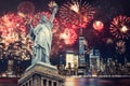 The Statue of Liberty with blurred background of cityscape and fireworks at night, Manhattan, New York City, USA