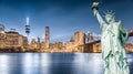 The Statue of Liberty with Brooklyn Bridge and Lower Manhattan background in the evening, Landmarks of New York City Royalty Free Stock Photo