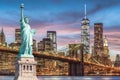 The Statue of Liberty and Brooklyn Bridge with World Trade Center background twilight sunset view, Landmarks of New York City