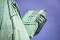 The Statue of Liberty a colossal neoclassical copper sculpture on Liberty Island, New York Harbor, NYC.Back view against blue sky Royalty Free Stock Photo