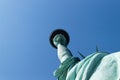 Statue of Liberty fragment, seen from a low angle, against blue clear sky, on the Liberty Island of New York, USA Royalty Free Stock Photo