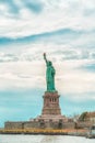 New York City Statue Of Liberty on Liberty Island Against Cloudy Blue Sky Background. Copy Space, Patriotism, Travel Concept. Ver Royalty Free Stock Photo