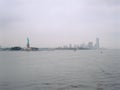 Statue of Liberty and Jersey City on a cloudy day. Royalty Free Stock Photo