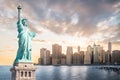 The Statue of Liberty with Lower Manhattan background in the evening at sunset, Landmarks of New York City Royalty Free Stock Photo