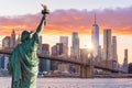 Statue Liberty and New York city skyline at sunset Royalty Free Stock Photo